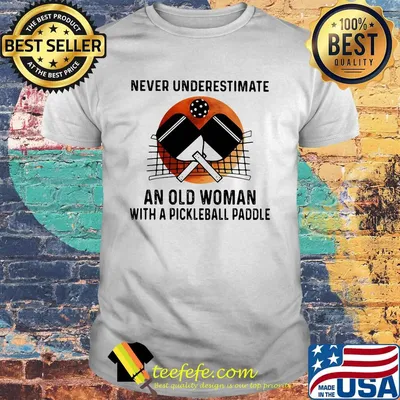 NEVER UNDERESTIMATE AN OLD WOMAN WITH A PICKLEBALL PADDLE SUNSET SHIRT