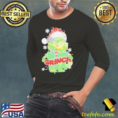 Santa hat in my Grinch era Christmas shirt